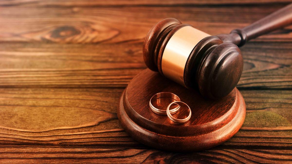 a pair of gold wedding rings, a judge's hammer