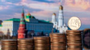 Coin with the symbol of the Russian ruble against the backdrop of the Moscow Kremlin