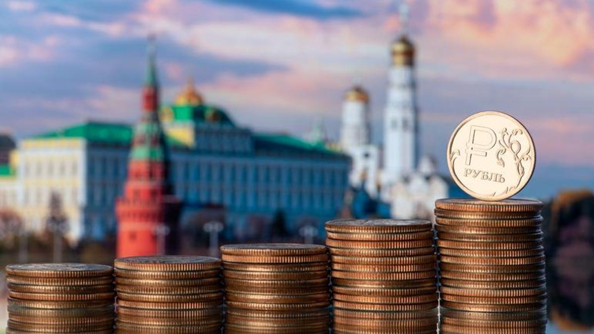 Coin with the symbol of the Russian ruble against the backdrop of the Moscow Kremlin