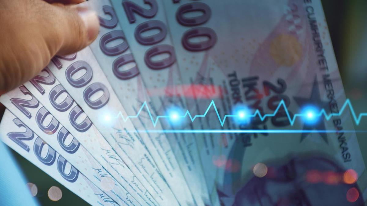 Turkish currency finance and economy concept. Hand holding Turkish lira banknotes with financial chart