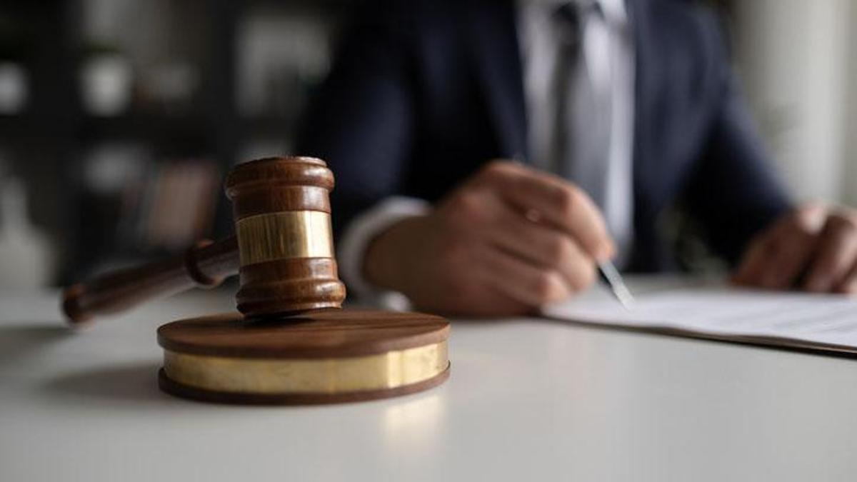 Judge or Legal advisor lawyer examining and signing legal documents.